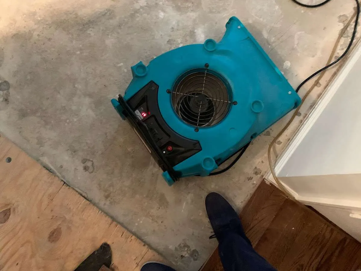 Air mover drying subfloor during Commercial Water Damage Restoration in North Vernon